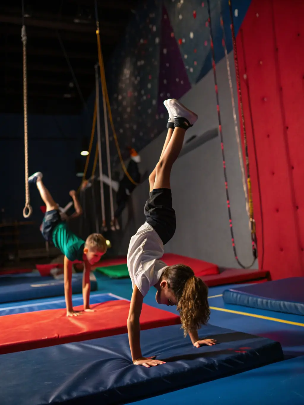 A dynamic photo of teenagers practicing acrobatics during a summer camp program at ECOLE DE CIRQUE : HORS PISTE, demonstrating teamwork and physical prowess.